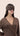 Woman wearing a brown sleep mask against a beige background | One of a Kin