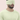 Man wearing a light green sleep mask against a pink background | One of a Kin